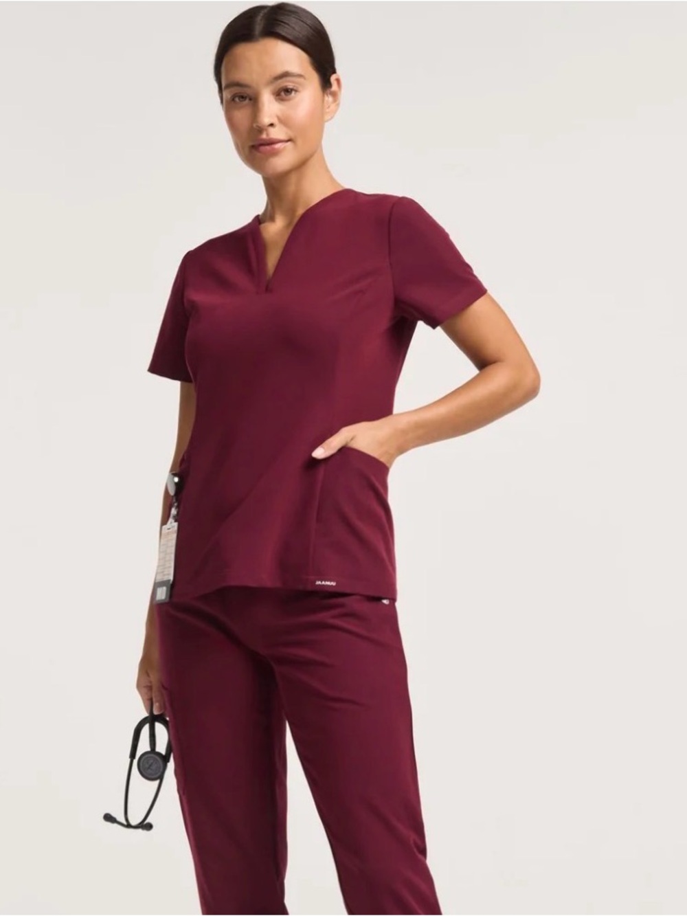 Jaanuu Calix fit & flare V notch Short Sleeve Scrub Top in Burgundy net Med